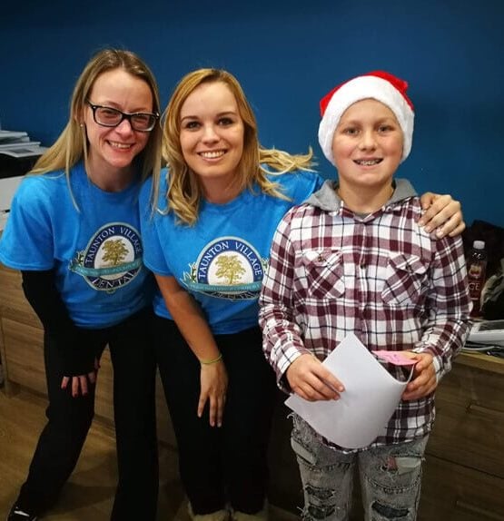 Dentistry with Heart volunteers and a kid smiling